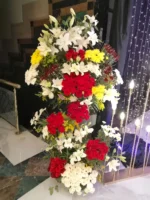 Remembrance Garden tall flower stand at an event by RosaBella Flowers